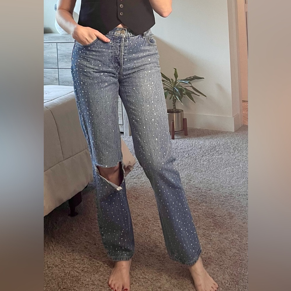 Women's Ripped Blue Jeans with stone design .